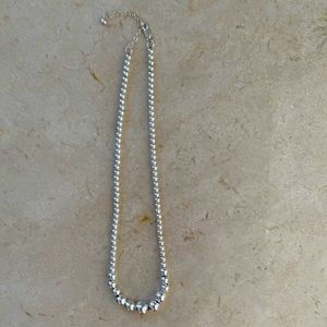 Silver graduated ball necklace.
